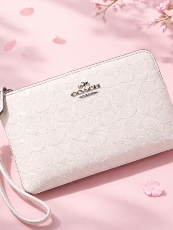 Coach Handbags - Coach Embossed Ivory Wristlet